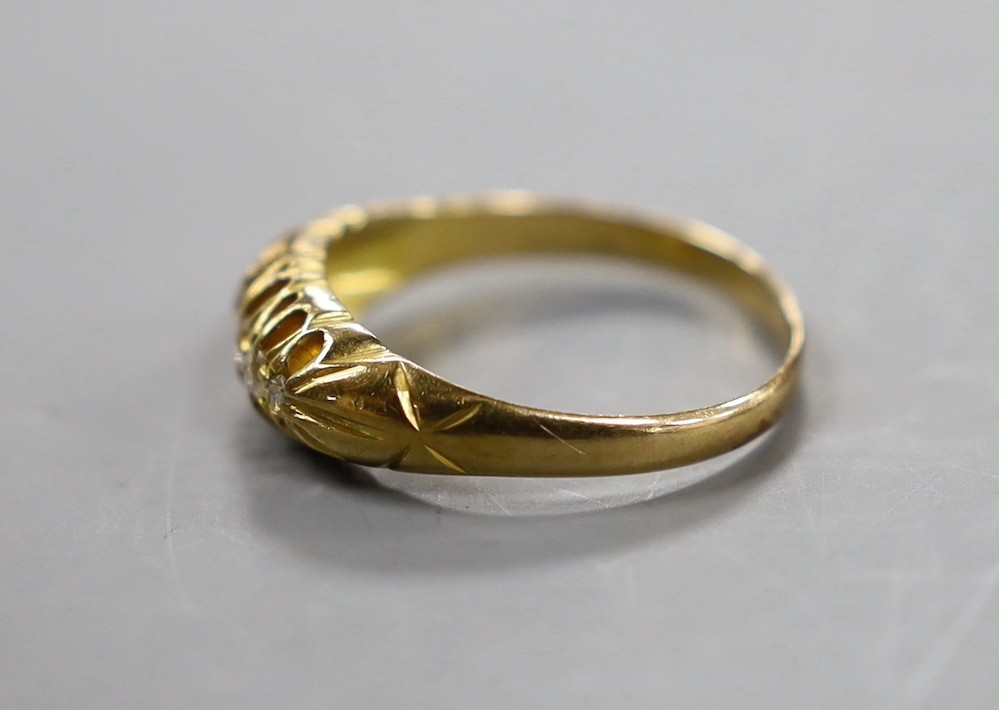 An early 20th century 18ct gold and graduated five stone diamond chip set half hoop ring, size Q, gross weight 3.2 grams.
